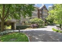 Beautiful multi-story building featuring brick and stone accents, lush landscaping, and a private entrance at 1717 N Decatur Ne Rd # 117, Atlanta, GA 30307