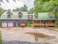 Charming log cabin home with connecting garage and a spacious front yard at 519 E Valley Ne Rd, Rydal, GA 30171