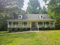 Charming single-story home with a welcoming front porch and well-manicured lawn at 8291 Highway 5, Whitesburg, GA 30185