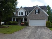 Charming two-story home with a well-manicured lawn and an attached two-car garage at 4576 Creek Forestt Trl, Lilburn, GA 30047
