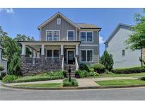 Charming two-story home featuring a welcoming front porch and beautifully landscaped front yard at 3621 Portland Trail Dr, Suwanee, GA 30024