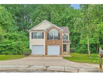 Charming two-story home with a two-car garage and a well-maintained front yard at 3599 Brookstone Way, Union City, GA 30291