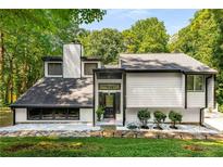 Contemporary home featuring a modern exterior, unique architectural details, and a well-maintained yard at 5219 Legendary Ln, Acworth, GA 30102