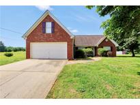 Charming brick home with a well-manicured lawn and attached two-car garage, perfect for suburban living at 502 Gallantry Trl, Mcdonough, GA 30252