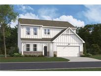 Charming two-story home with white siding, a brick foundation and an attached two-car garage at 138 Henley St, Canton, GA 30114