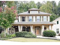 Charming two-story home with a welcoming front porch and manicured landscaping at 2439 Muirfield Pl, Atlanta, GA 30337