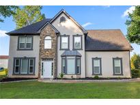 Charming two-story home with stone facade and manicured lawn in a suburban neighborhood at 4186 Stillwater Pt, Ellenwood, GA 30294