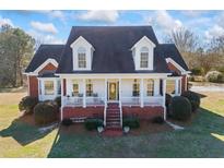 Charming brick home with a welcoming front porch and well-maintained landscaping at 1650 Old Loganville Rd, Loganville, GA 30052