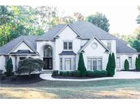 Stunning two-story home with manicured lawn, a circular driveway, and a stately facade at 3258 Bransley Way, Duluth, GA 30097