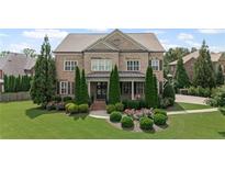 Inviting brick two-story home with manicured lawn and mature landscaping at 103 Brightmoor Ct, Canton, GA 30115