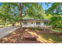 Charming single-story home with green shutters, front yard, and covered parking at 245 Amanda Ct, Stockbridge, GA 30281