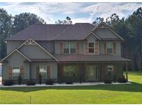 Charming two-story home with gray siding, craftsman accents, and a welcoming front porch at 2647 Old Snapping Shoals Rd, Mcdonough, GA 30252