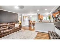 Inviting living room with a brown leather sofa, open to the dining area and kitchen, offering a seamless living space at 4266 Roswell Ne Rd # L3, Atlanta, GA 30342