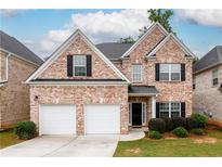 Charming two-story brick home featuring a two-car garage and well-maintained landscaping at 1076 Scenic Park Trl, Lawrenceville, GA 30046