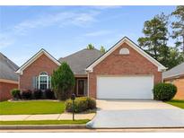 Charming single-story brick home featuring a two-car garage and well-maintained landscaping at 115 Pinnacle Ln, Mcdonough, GA 30253