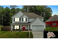 Charming two-story home with a well-manicured lawn, two-car garage, and inviting red front door at 255 Webster Lake Dr, Temple, GA 30179