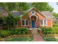 Charming brick home with a well-manicured lawn and inviting front porch steps at 608 Hardendorf Ne Ave, Atlanta, GA 30307