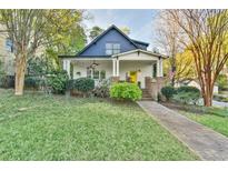 Charming home featuring a welcoming front porch, lush lawn, and mature landscaping, inviting curb appeal at 907 Eden Se Ave, Atlanta, GA 30316