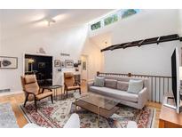 Open living room with hardwood floors, modern furniture, and vaulted ceilings, offering bright, comfortable space at 2960 Cedar Knoll Dr, Roswell, GA 30076