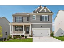 Charming two-story home featuring gray siding, black shutters, a covered porch, and an attached two-car garage at 96 Quail Bend Way, Dallas, GA 30157