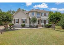 Charming two-story home with a well-manicured lawn, beautiful landscaping, and inviting curb appeal at 1745 Stoney Brook Way, Alpharetta, GA 30005