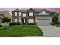 Beautiful two-story home with well-manicured lawn, gray brick, and two-car garage at 4650 Orchard View Way, Cumming, GA 30028