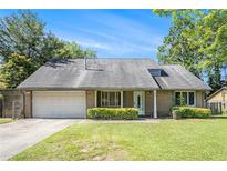 Charming single-story home featuring a manicured lawn and attached two-car garage at 3080 Keenan Rd, Atlanta, GA 30349