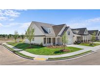 Stunning new construction features beautiful landscaping, a covered front porch, and neutral-colored exterior at 1659 Tielman Way, Snellville, GA 30078