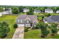 Charming brick-and-siding home featuring a well-manicured lawn and attached two-car garage at 2127 Grant Ave, Mcdonough, GA 30252