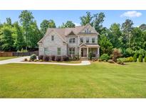 Beautiful two-story brick home with a well-manicured lawn and lush landscaping in a suburban setting at 355 Glynnwilde Nw Dr, Marietta, GA 30064