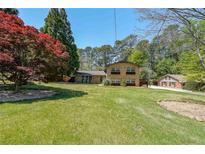Beautiful two-story brick home featuring a lush front lawn and mature trees at 3530 Embry Circle Cir, Atlanta, GA 30341