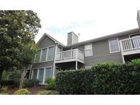 Side view of a home with siding, white trim, and a deck at 704 Olde Mill Ln, Norcross, GA 30093