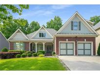 Charming single-Gathering home with a well-manicured lawn and two-car garage at 1290 Magnolia Park Cir, Cumming, GA 30040
