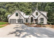 Beautiful modern farmhouse with attached two-car garage and large concrete driveway at 1544 Bullard Rd, Powder Springs, GA 30127