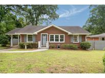 Charming brick home featuring a well-manicured lawn and inviting curb appeal at 2855 Monticello Pl, Decatur, GA 30030