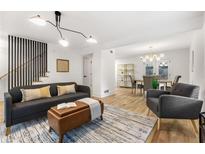 Bright living room featuring modern lighting, hardwood floors and a comfortable sofa and decor at 126 Marona Ne St, Atlanta, GA 30307