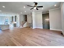Spacious living room features hardwood floors and modern ceiling fan at 285 Briscoe Way # 2, Alpharetta, GA 30009