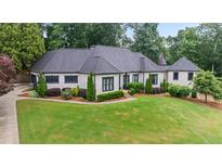 Beautiful home showcasing well-manicured lawn, lush landscaping, and a charming exterior design at 4030 River Ridge Se, Marietta, GA 30067