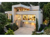 Modern home with a two-car garage, balcony, manicured landscaping and large windows at 1242 Wild Creek Ne Trl, Atlanta, GA 30324
