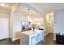 Bright kitchen featuring marble island, stainless steel appliances, and modern lighting at 3060 Pharr Court North Nw # 719, Atlanta, GA 30305