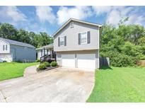 Charming two-story home with a spacious driveway and well-maintained front yard at 409 Ivy Terrace Dr, Dallas, GA 30157