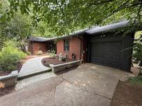 Charming brick home with a well-maintained lawn and a large, two-car attached garage at 2413 N. Decatur Rd, Decatur, GA 30033