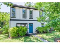 Charming two-story home featuring a bright blue front door and lush landscaping at 2405 Hillside Ave, Decatur, GA 30032