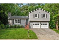Charming two-story home with a well-manicured lawn and a two-car garage at 3919 Valley Brook Rd, Snellville, GA 30039