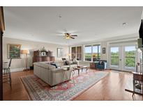 Spacious living room with hardwood floors and balcony access with an open floor plan at 3330 Overland Dr, Roswell, GA 30075