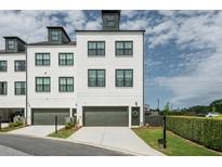 Contemporary townhome with painted brick, 1-car garage and manicured landscaping at 6895 Whitman Walk, Alpharetta, GA 30005