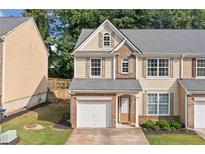 Charming two-story home with a one car garage and a well maintained lawn at 4161 Magnolia Glen Walk, Norcross, GA 30093