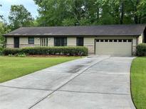 Charming single-story home with a well-manicured front yard and extended concrete driveway at 4323 Darwen Ct, Tucker, GA 30084
