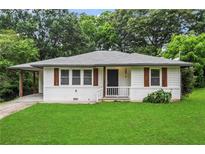 Charming single-story home featuring white paint, wood shutters, and a well-maintained lawn at 629 Dunton Se Cir, Smyrna, GA 30082