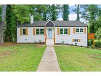 Charming home with a brick facade, a light blue front door, and wooden shutters at 1995 Venetian Sw Dr, Atlanta, GA 30311